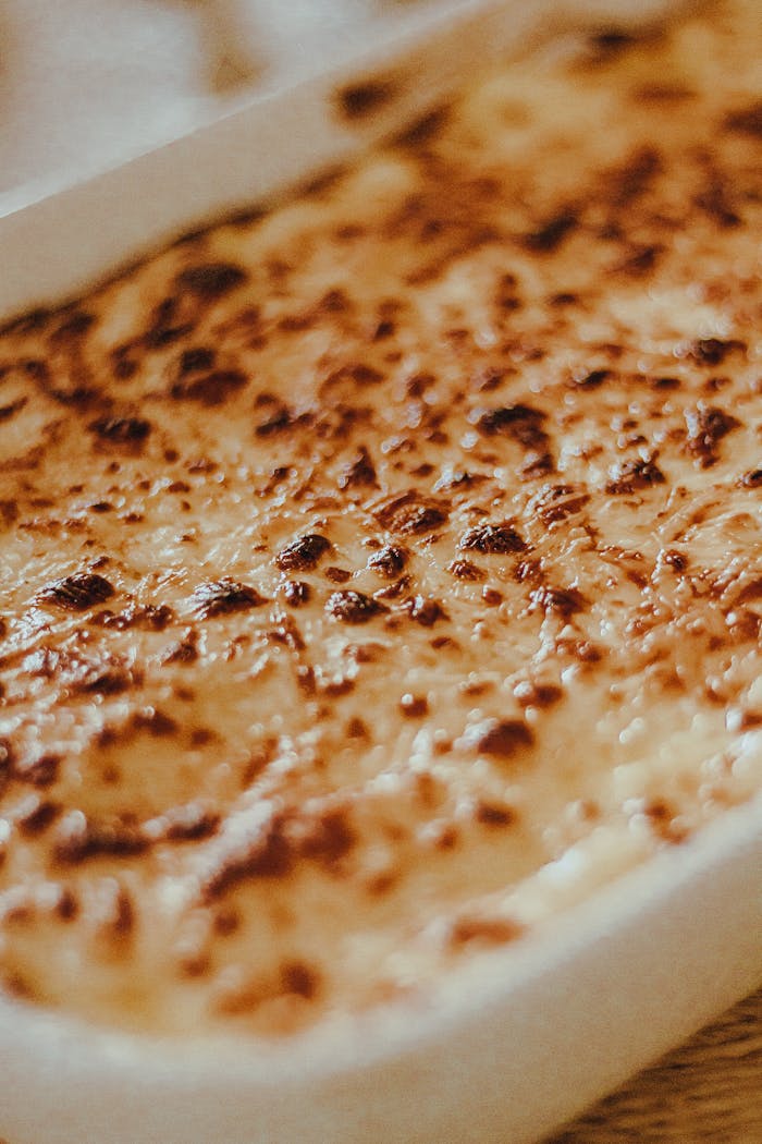 Close-up of a baked lasagna with melted cheese, perfect for Italian cuisine lovers.